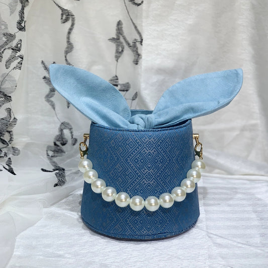 Handmade Zhuang Brocade Bunny-Ear Bucket Bag | Artisan-Crafted Ethnic Crossbody Bag with Pearl Accent