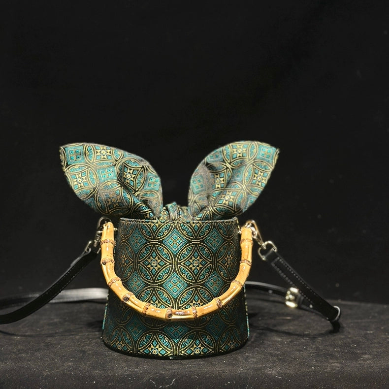 Handmade Zhuang Brocade Mini Bucket Bag with Bamboo Handle | Artisan Crafted Ethnic Crossbody Bag with Blue Tassel Charm