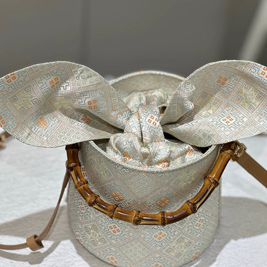 Handmade Zhuang Brocade Bucket Bag with Bamboo Handle | Artisan Crafted Ethnic Crossbody Bag with Bunny-Ear Brocade Flap