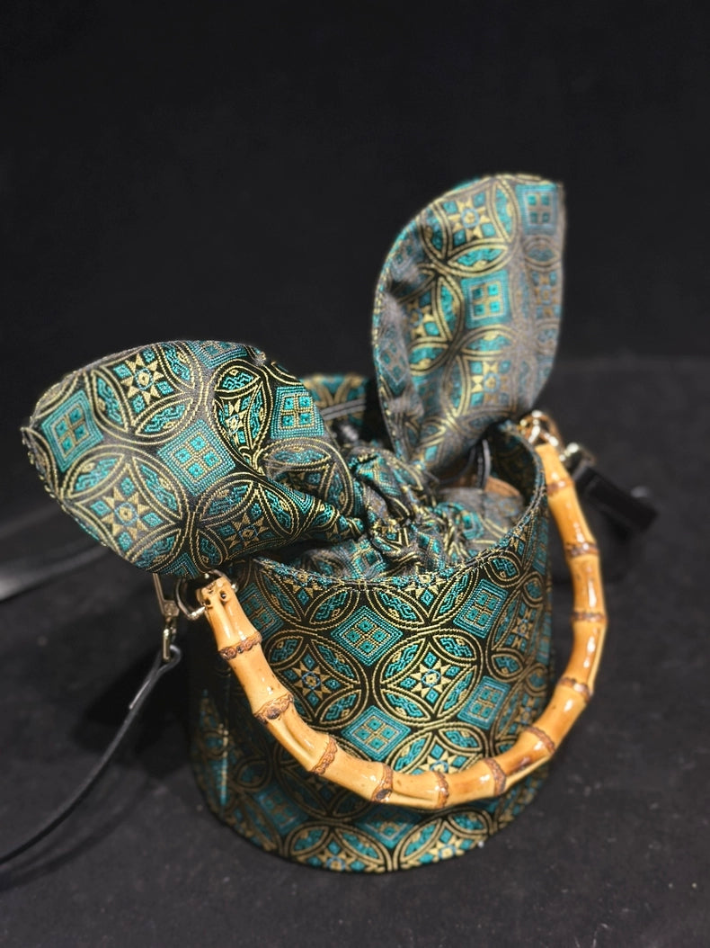 Handmade Zhuang Brocade Mini Bucket Bag with Bamboo Handle | Artisan Crafted Ethnic Crossbody Bag with Blue Tassel Charm