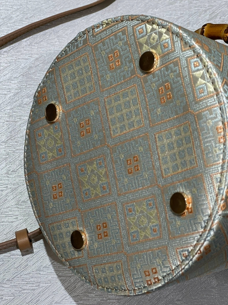 Handmade Zhuang Brocade Bucket Bag with Bamboo Handle | Artisan Crafted Ethnic Crossbody Bag with Bunny-Ear Brocade Flap