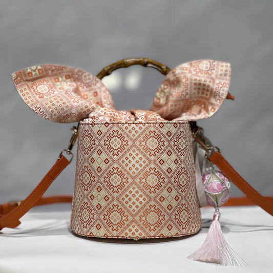 Handmade Zhuang Brocade Bucket Bag with Bamboo Handle | Artisan Crafted Ethnic Crossbody Bag with Pink Tassel Charm