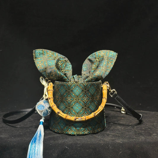 Handmade Zhuang Brocade Mini Bucket Bag with Bamboo Handle | Artisan Crafted Ethnic Crossbody Bag with Blue Tassel Charm
