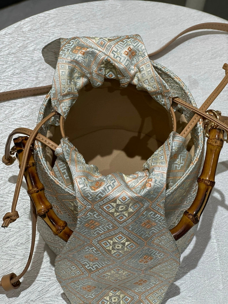 Handmade Zhuang Brocade Bucket Bag with Bamboo Handle | Artisan Crafted Ethnic Crossbody Bag with Bunny-Ear Brocade Flap