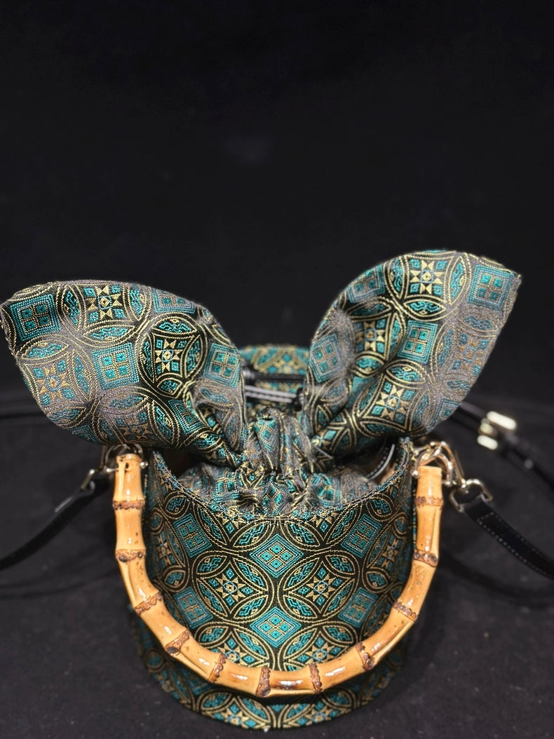 Handmade Zhuang Brocade Mini Bucket Bag with Bamboo Handle | Artisan Crafted Ethnic Crossbody Bag with Blue Tassel Charm